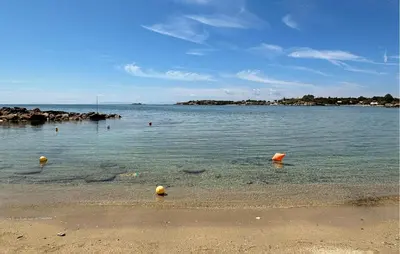 a body of water with a beach with balls in it at Gorgeous Home In Lagonisi With Wifi in Lagonissi