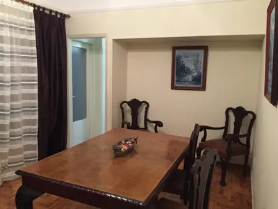 a dining room with a wooden table and chairs at Rustic in Athens