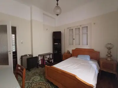 a bedroom with a large bed and a window at Rustic in Athens