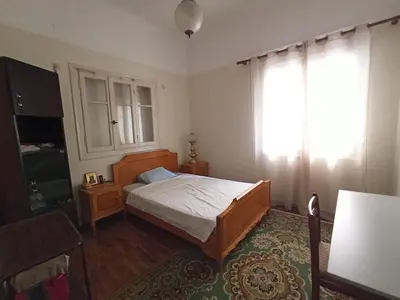 a bedroom with a bed and a window at Rustic in Athens