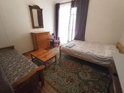 a bedroom with two beds and a dresser and a window at Rustic in Athens