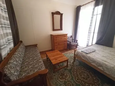 a bedroom with two beds and a dresser and a mirror at Rustic in Athens