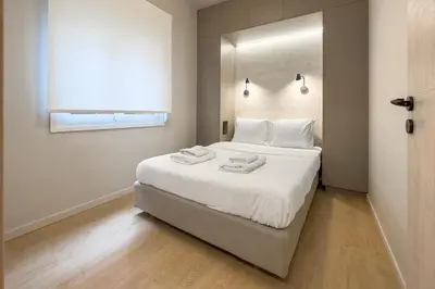 a bedroom with a large bed with two towels on it at Cozy 1BR with Balcony in Kipseli in Athens