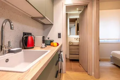a kitchen with a large white sink in a room at Cozy 1BR with Balcony in Kipseli in Athens