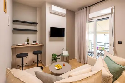 a living room with a couch and a table at Cozy 1BR with Balcony in Kipseli in Athens