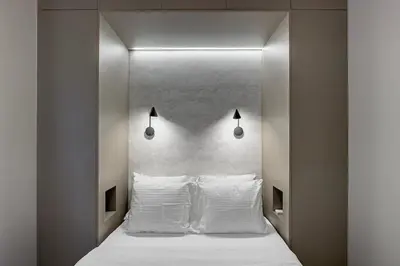 a bedroom with a white bed with white pillows at Cozy 1BR with Balcony in Kipseli in Athens