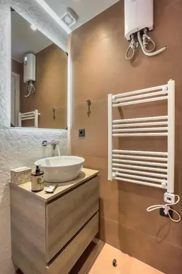 a bathroom with a sink and a mirror at Cozy 1BR with Balcony in Kipseli in Athens
