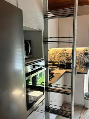 a kitchen with a glass wall with a painting at 3R-in-3V in Vari