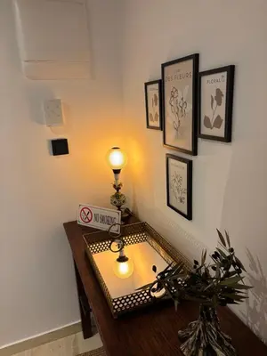 a room with a table with a lamp on it at 3R-in-3V in Vari