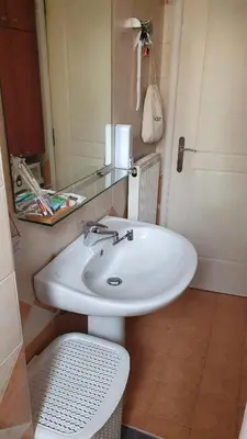 a bathroom with a white sink and a mirror at Vresthenisden in Athens