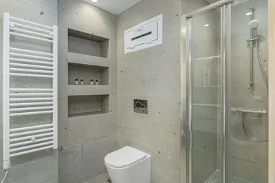 a bathroom with a toilet and a glass shower at Modern & Elegant Getaway near Pasalimani in Piraeus