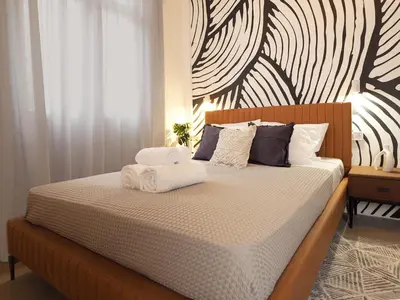 a bedroom with a bed with towels on it at Graffiti House in Athens