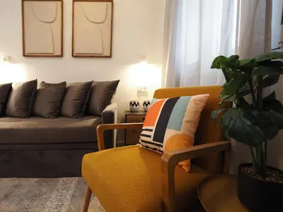 a living room with a couch and a chair at Graffiti House in Athens