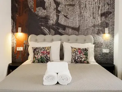 a bedroom with a bed with two towels on it at Graffiti House in Athens