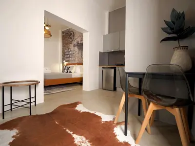 a living room with a table and a chair at Graffiti House in Athens