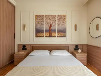 a bedroom with a bed and a painting on the wall at Mixalakopoulou Luxury Apartment in Athens
