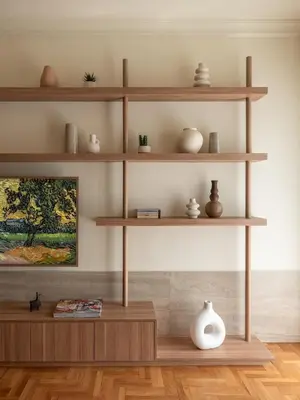 a room with wooden shelves with vases and a painting at Mixalakopoulou Luxury Apartment in Athens