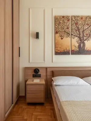 a bedroom with a bed and a picture on the wall at Mixalakopoulou Luxury Apartment in Athens