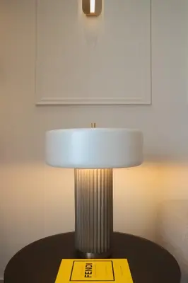 a lamp on a table with a yellow tag on it at Mixalakopoulou Luxury Apartment in Athens