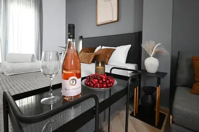 a bottle of wine and a glass on a table in a living room at Sokratous house in Athens