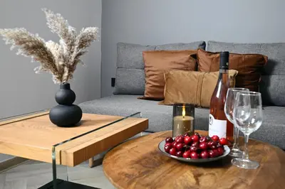 a table with a bottle of wine and a bowl of cherries at Sokratous house in Athens