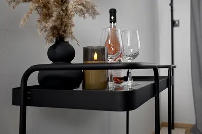 a black table with a candle and wine glasses at Sokratous house in Athens