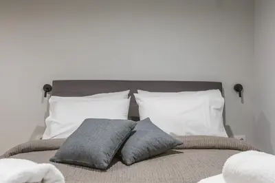 a bed with two pillows on top of it at Raise Egaleo Campus in Athens