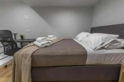 a bedroom with a bed with towels on it at Raise Egaleo Campus in Athens