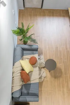 an overhead view of a couch with pillows and a plant at Raise Egaleo Campus in Athens