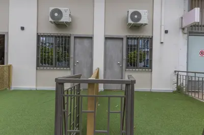 a batting cage with a bat in front of a building at Raise Egaleo Campus in Athens