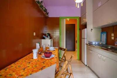a kitchen with a table with chairs and a counter top at Dorina's Ath-seaside Apartment in Athens