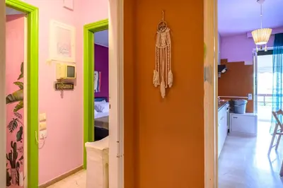 a hallway with a room with colorful walls at Dorina's Ath-seaside Apartment in Athens