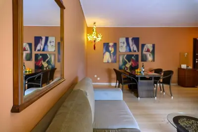 a living room with a couch and a mirror at Dorina's Ath-seaside Apartment in Athens