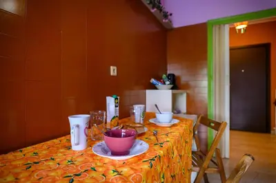 a table with plates and bowls on top of it at Dorina's Ath-seaside Apartment in Athens