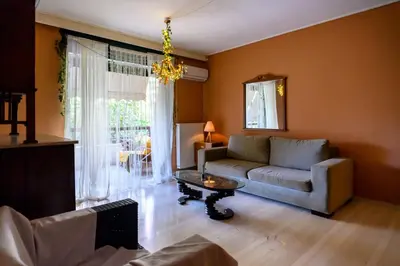 a living room with a couch and a table at Dorina's Ath-seaside Apartment in Athens