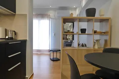 a kitchen and a dining room with a table at Stylish city studio by MPS in Athens