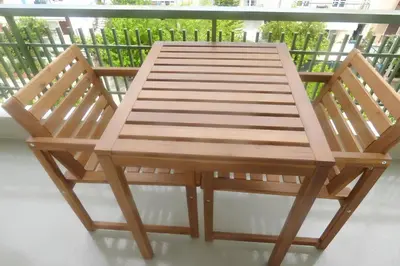 a wooden bench sitting on top of a balcony at Stylish city studio by MPS in Athens