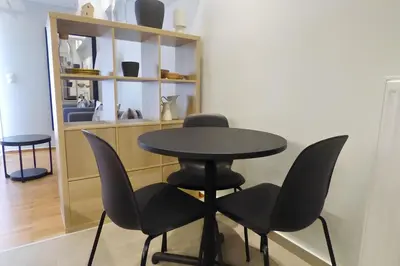 a black table and chairs in a room at Stylish city studio by MPS in Athens