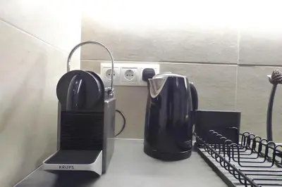 a coffee maker sitting on top of a kitchen counter at Stylish city studio by MPS in Athens