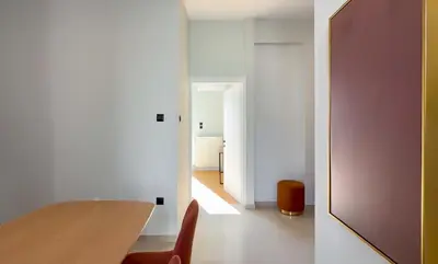 a room with a table and chairs and a hallway at Athenian metro apartments in Athens