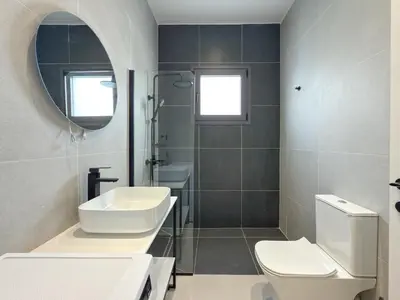 a bathroom with a sink and a toilet and a mirror at Athenian metro apartments in Athens