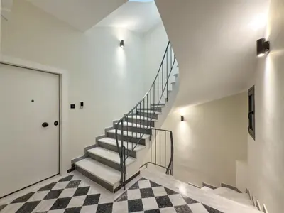 a staircase in a house with a checkered floor at Athenian metro apartments in Athens
