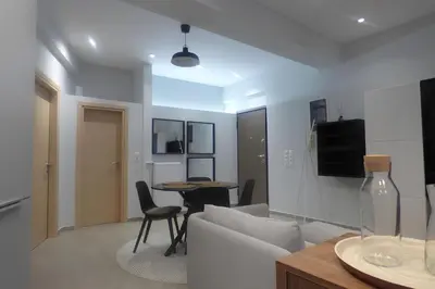 a living room with a couch and a table at Stylish city Apartment for 4 by MPS in Athens