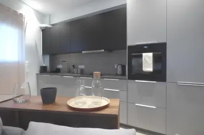 a kitchen with a table with a bottle and glasses at Stylish city Apartment for 4 by MPS in Athens