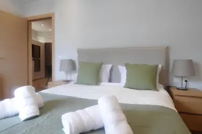 a bedroom with a large white bed with four pillows at Stylish city Apartment for 4 by MPS in Athens