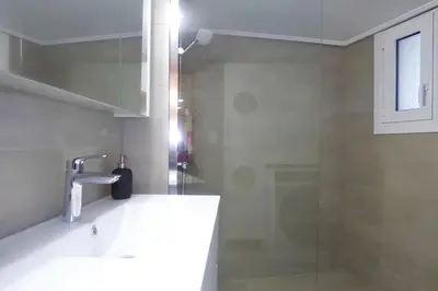 a bathroom with a sink and a shower at Stylish city Apartment for 4 by MPS in Athens