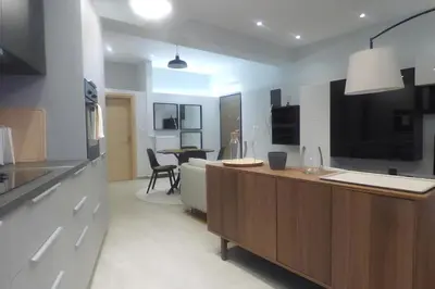 a kitchen with a counter and a table in a room at Stylish city Apartment for 4 by MPS in Athens