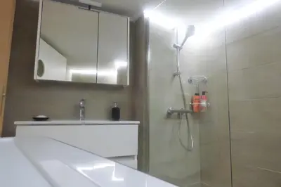 a bathroom with a shower and a sink and a mirror at Stylish city Apartment for 4 by MPS in Athens