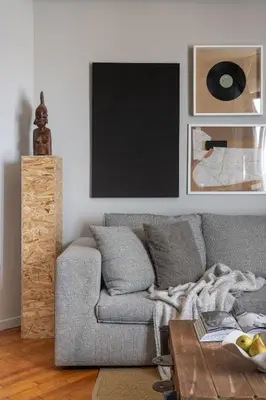 a living room with a gray couch and a table at The Apartment 09 in Athens