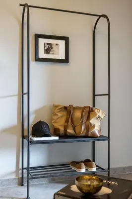 a metal shelf with a purse and shoes on it at The Apartment 09 in Athens